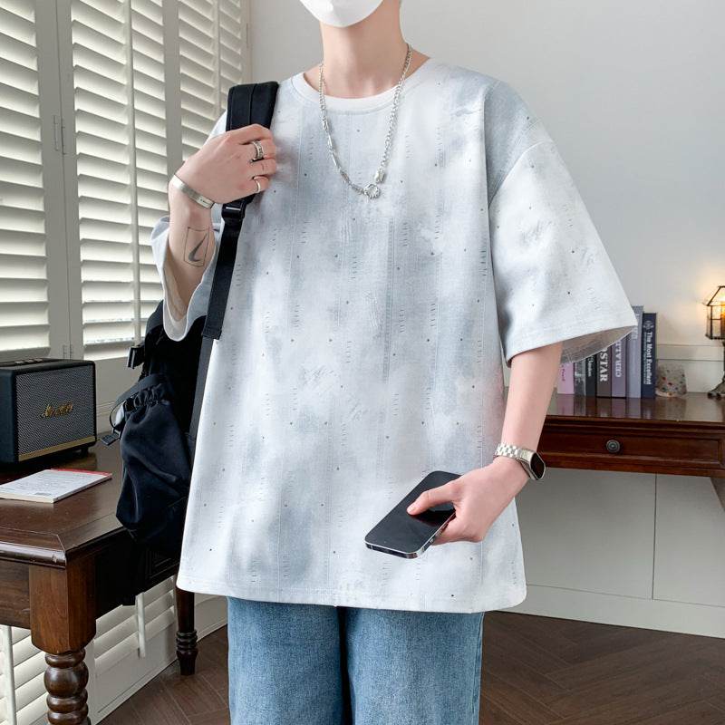 Men wearing a stylish minimalist t-shirt for men in a casual setting with a phone in hand