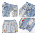 Moomins Cartoon Jeans featuring colorful character designs and floral motifs on denim fabric