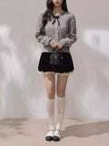 AM Vision RO Moonlight Ribbon Cardigan in gray with a bow detail, paired with a black skirt and knee-high socks
