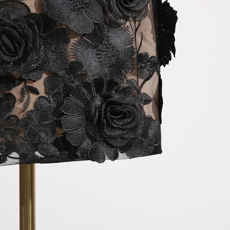 Close-up of the Naked Illusion Dress With Embroidered Flowers showcasing intricate black floral details