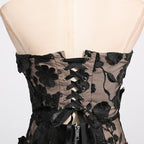 Back view of the Naked Illusion Dress With Embroidered Flowers featuring lace-up design and floral embroidery.