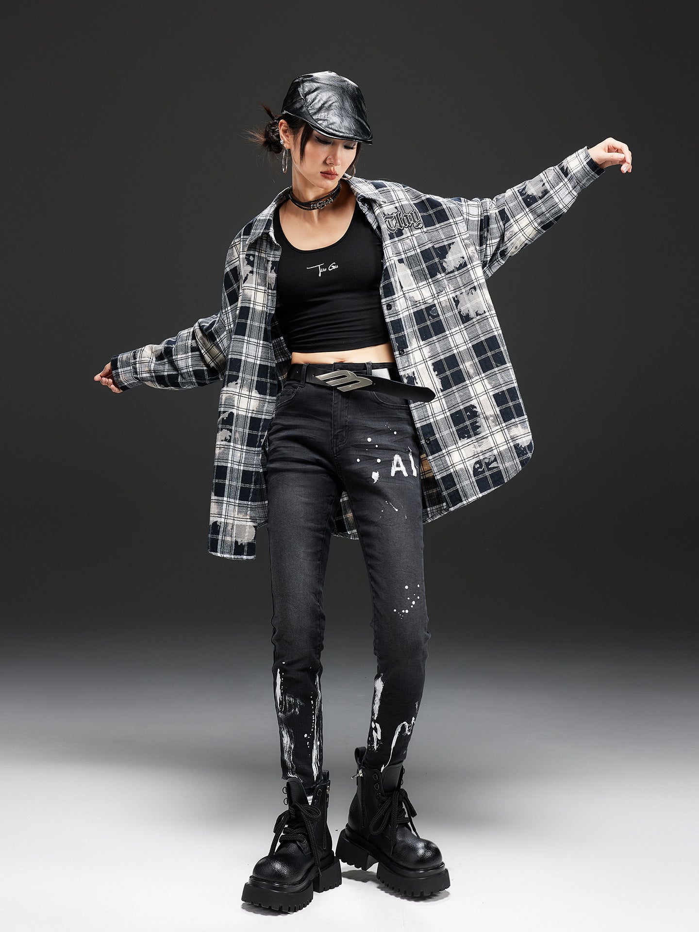 Model wearing Night Rider Painted Skinny Jeans paired with a plaid shirt and black boots for a stylish look