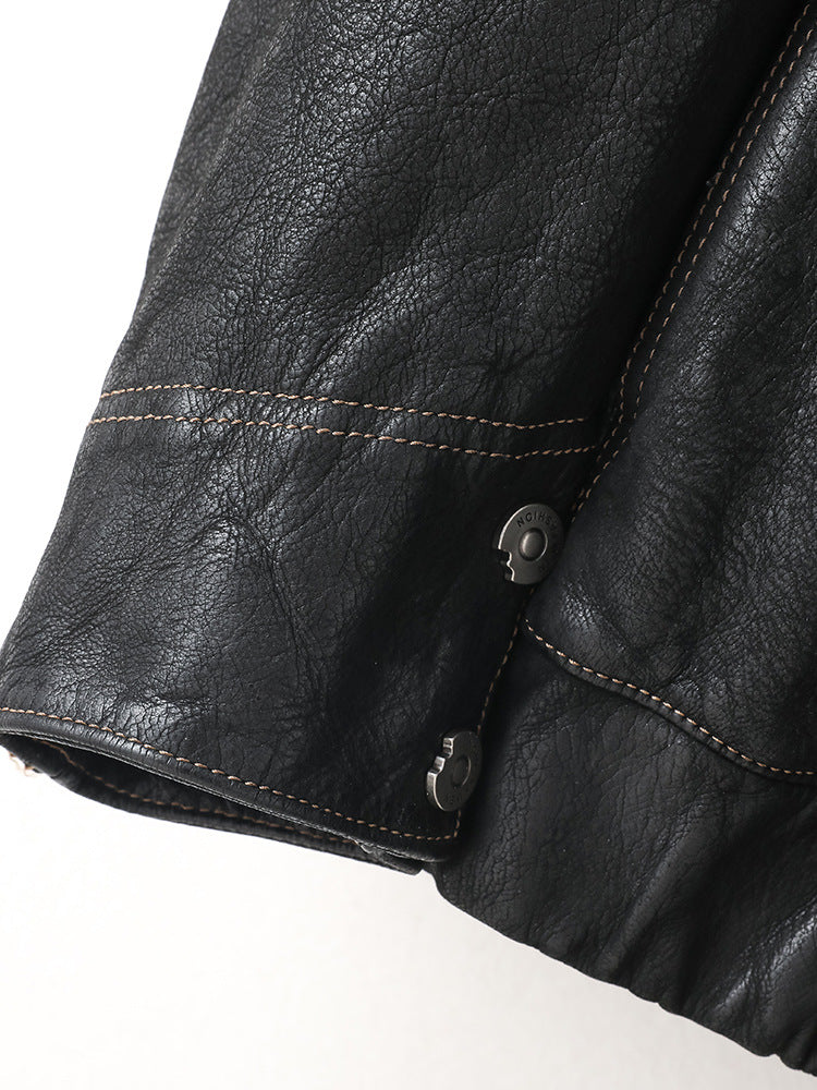 Close-up of Noir Atlas Hooded Goatskin Jacket sleeve detail featuring stylish snap buttons