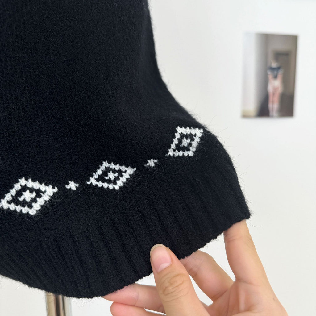Detail of Nordic Echo Knit Set showing a stylish black sweater with geometric white patterns