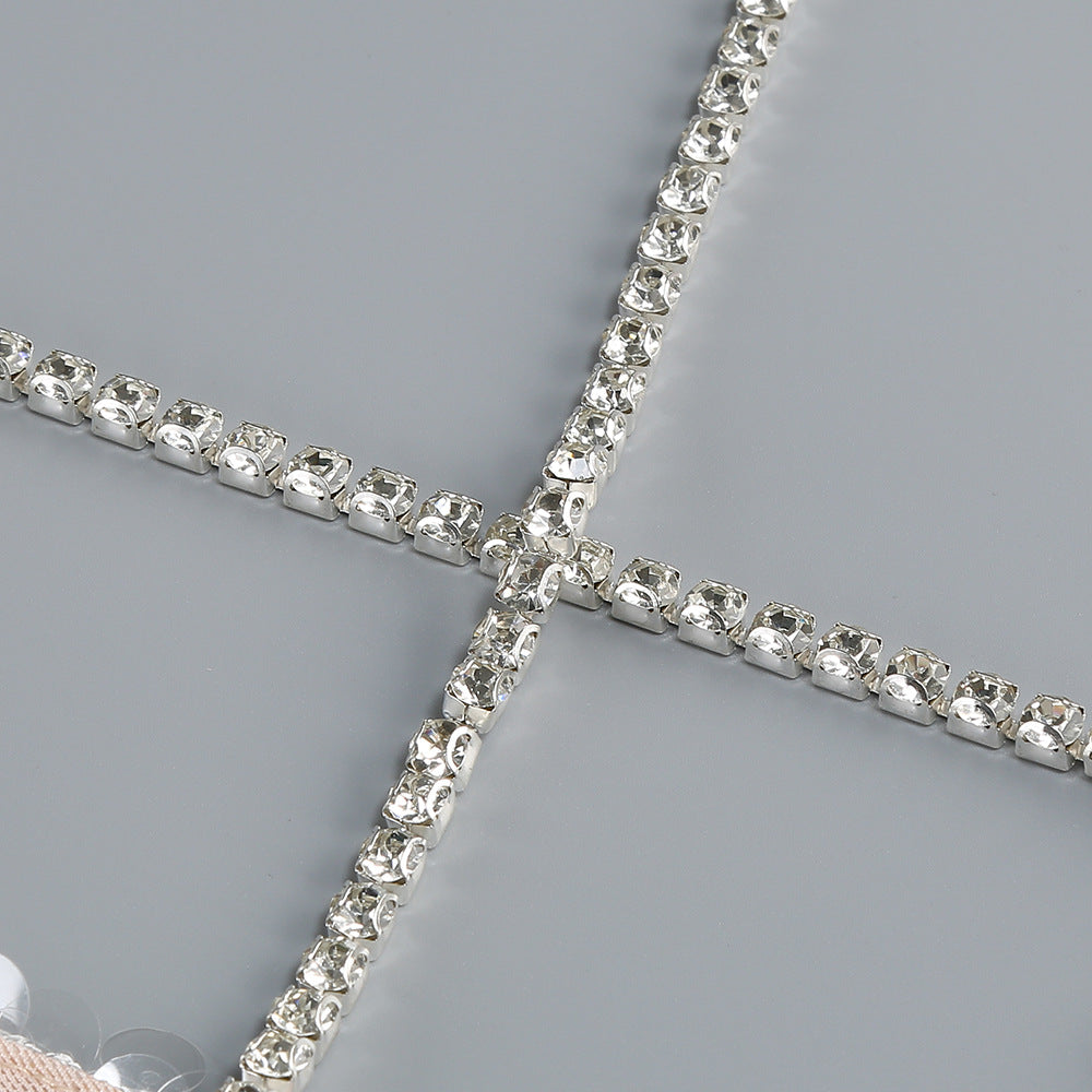 Close-up of the sparkling details on an AM Vision RO One-Shoulder Sequin Gown featuring intricate embellishments