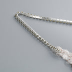 Close-up of the strap detail on an AM Vision RO One-Shoulder Sequin Gown showcasing elegant embellishments