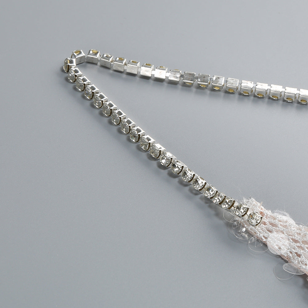 Close-up of the strap detail on an AM Vision RO One-Shoulder Sequin Gown showcasing elegant embellishments