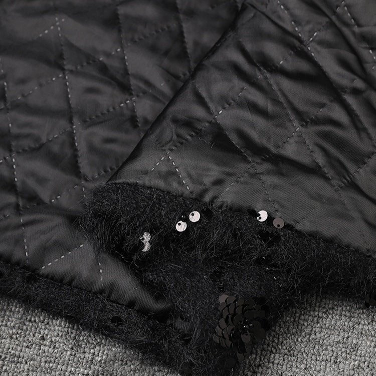 Close-up of AM Vision RO Oversize Jacket with Applications featuring quilted fabric and sequin detailing