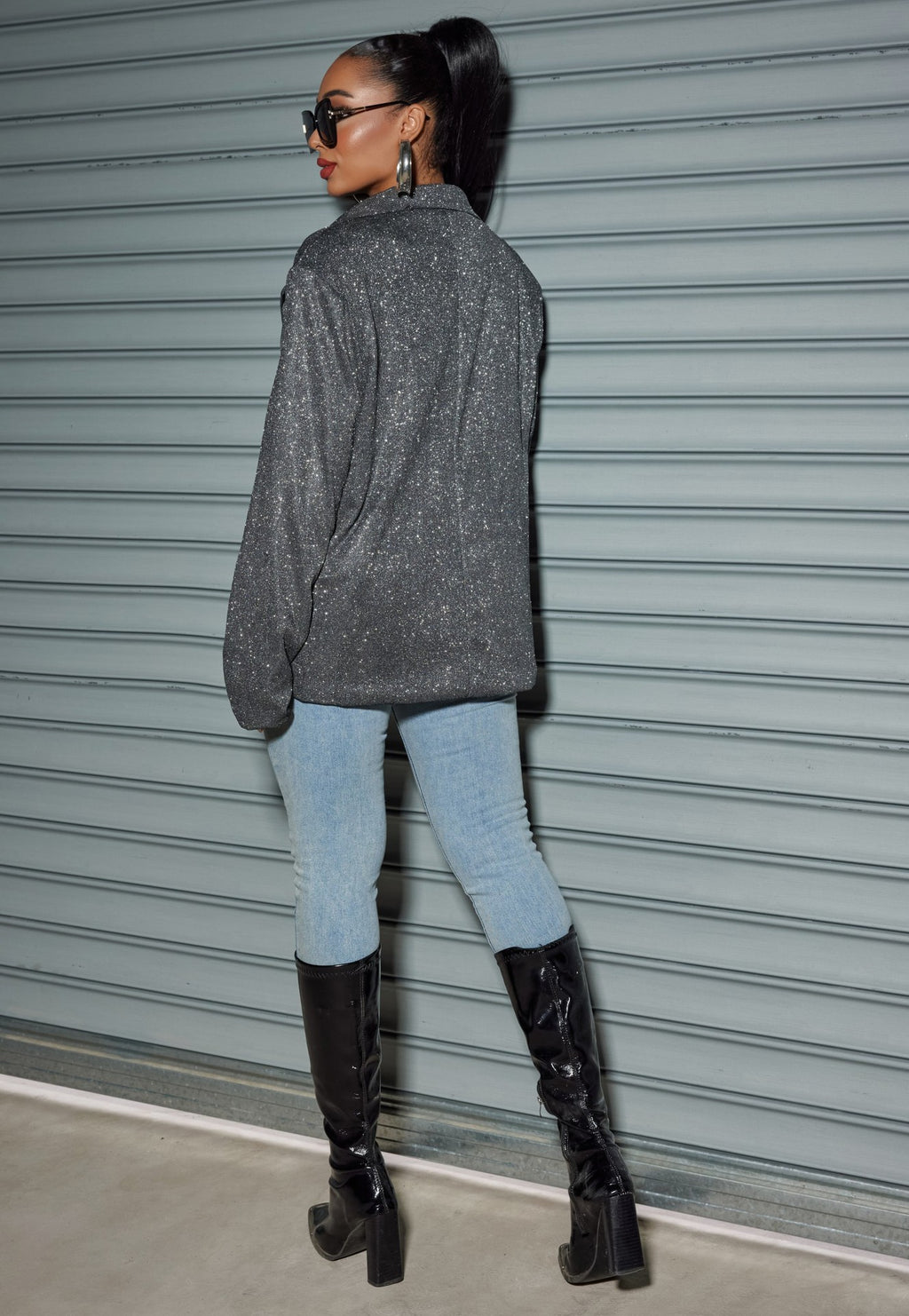 Chic model wearing an Oversized Sequin Cardigan Blazer with stylish jeans and tall black boots