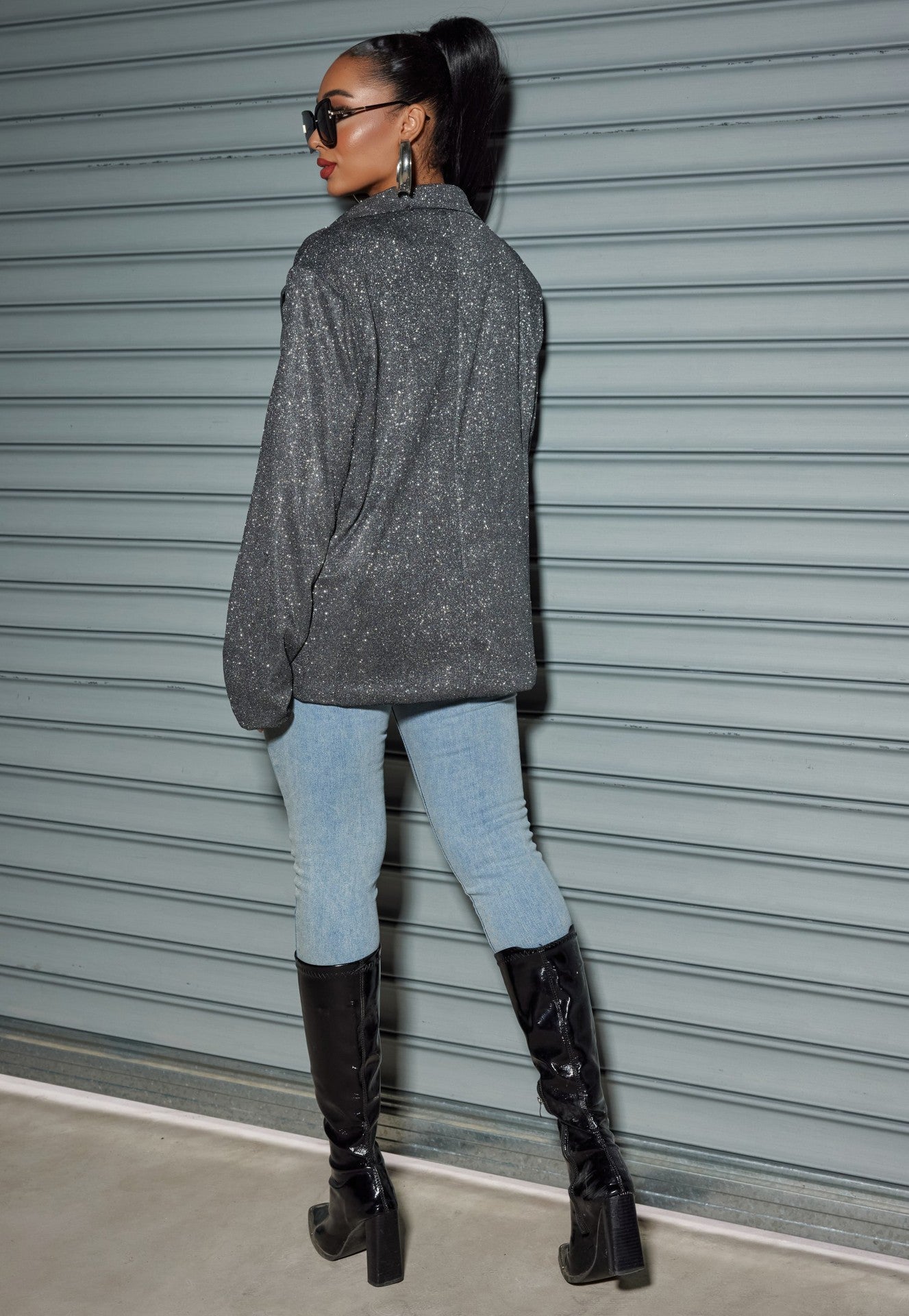Chic model wearing an Oversized Sequin Cardigan Blazer with stylish jeans and tall black boots
