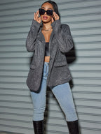 Stylish woman wearing an Oversized Sequin Cardigan Blazer with chic sunglasses and light jeans