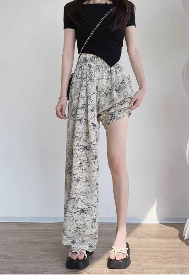 Pantaloni asimetrici de dama cu un picior lung si imprimeu floral alb-negru AM Vision RO