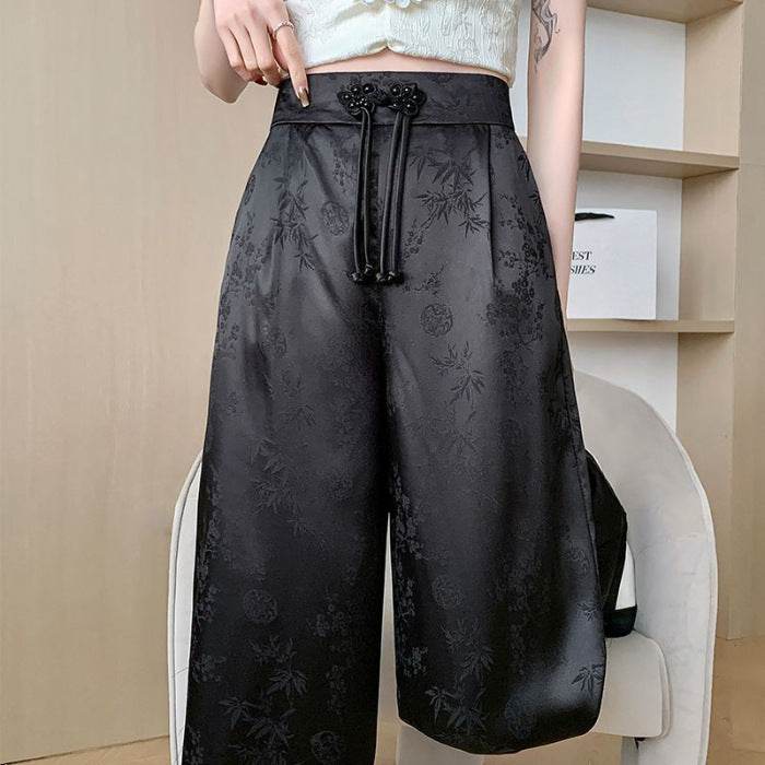Pantaloni largi negri din material satinat cu model floral subtil și talie înaltă cu șnur ajustabil