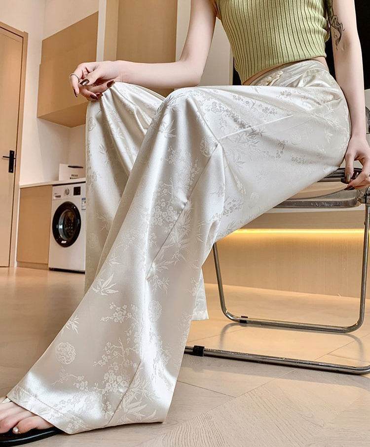 Pantaloni largi din satin cu model floral subtil, eleganți și comozi pentru ținute casual sau de ocazie