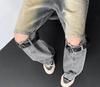 Stylish prewashed streetwear jeans with distressed detailing and belt accents, perfect for trendy outfits