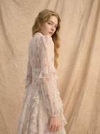 Model wearing Provence Bloom Midi Dress featuring floral patterns and ruffled sleeves