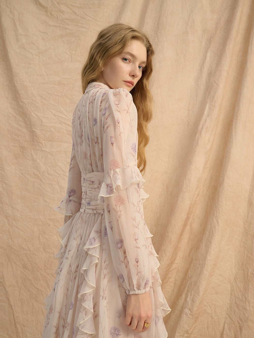 Model wearing Provence Bloom Midi Dress featuring floral patterns and ruffled sleeves