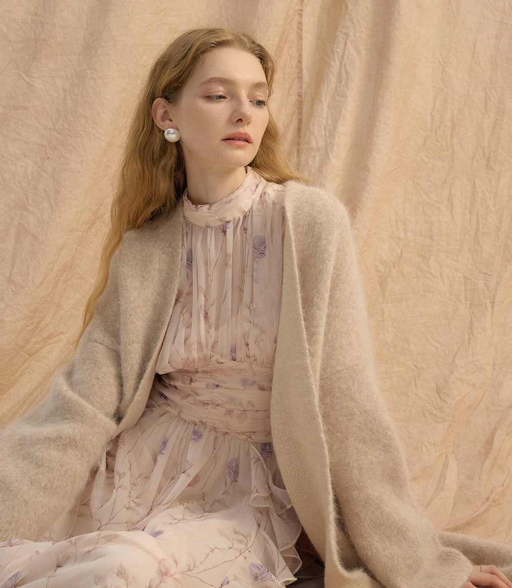 Model wearing a Provence Bloom Midi Dress with soft floral patterns and a cozy cardigan