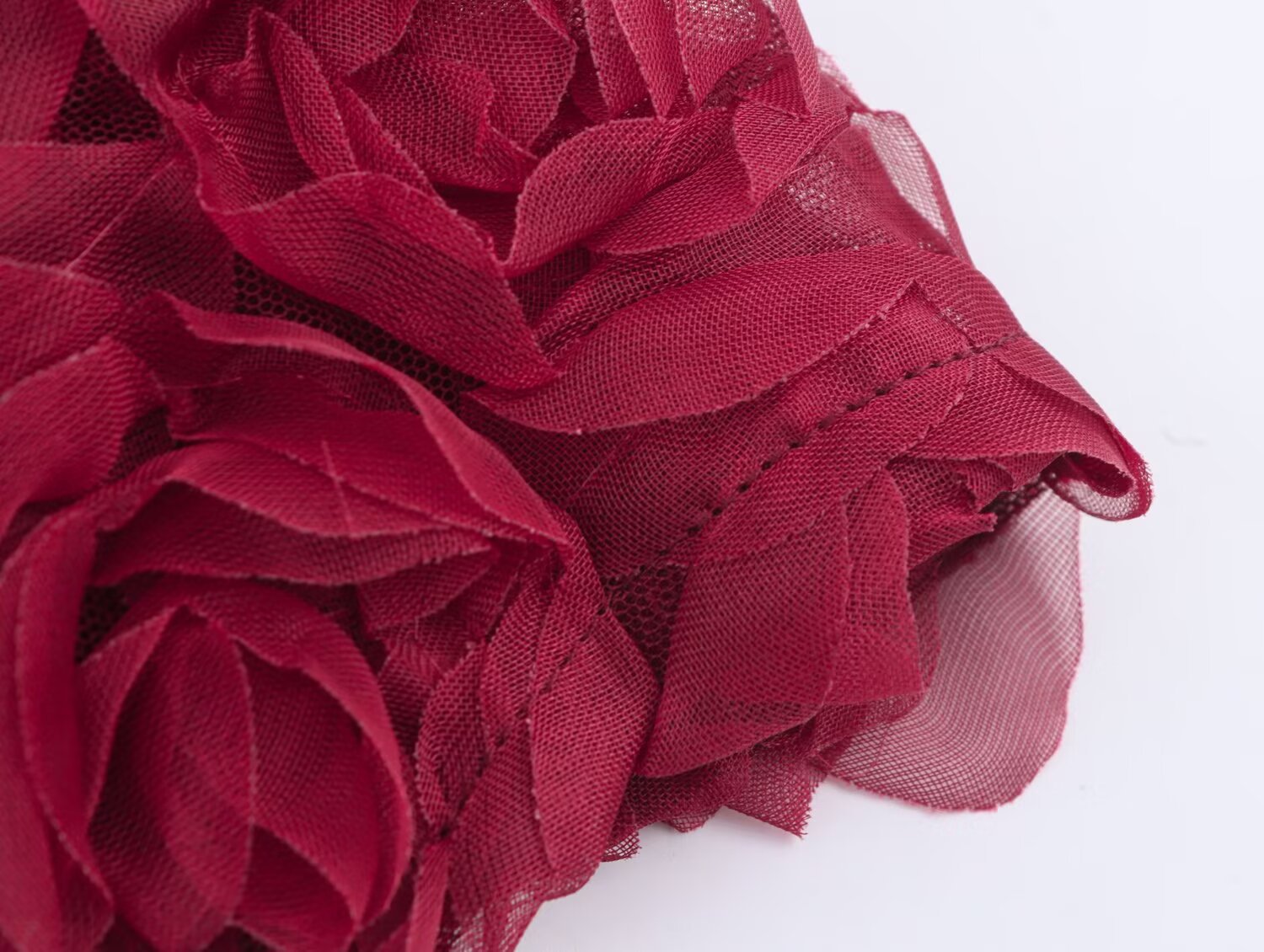 Detail of a Red Rose Blossom Dress featuring textured floral patterns for a romantic look