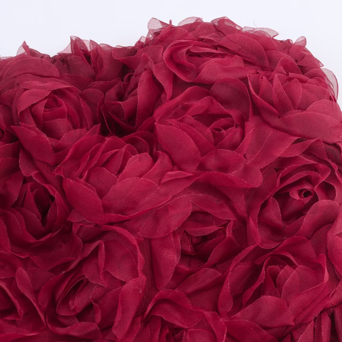 Close-up view of the Red Rose Blossom Dress featuring beautiful layered fabric roses for a vibrant look