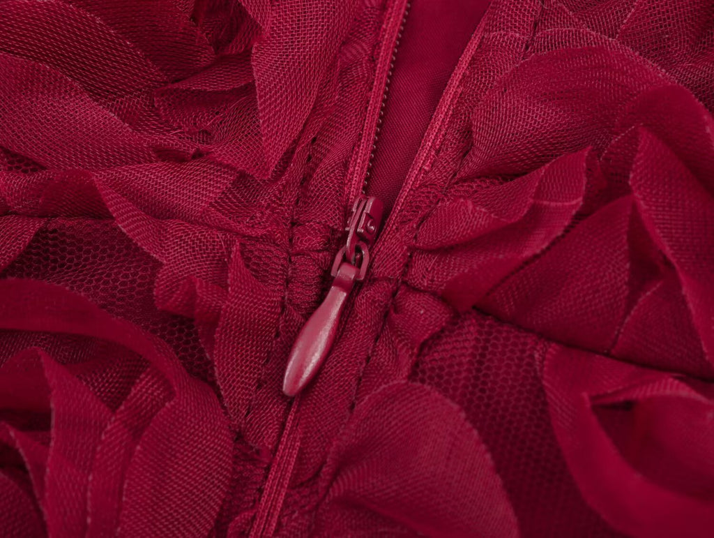 Close-up of zipper detail on the Red Rose Blossom Dress featuring floral fabric and elegant design