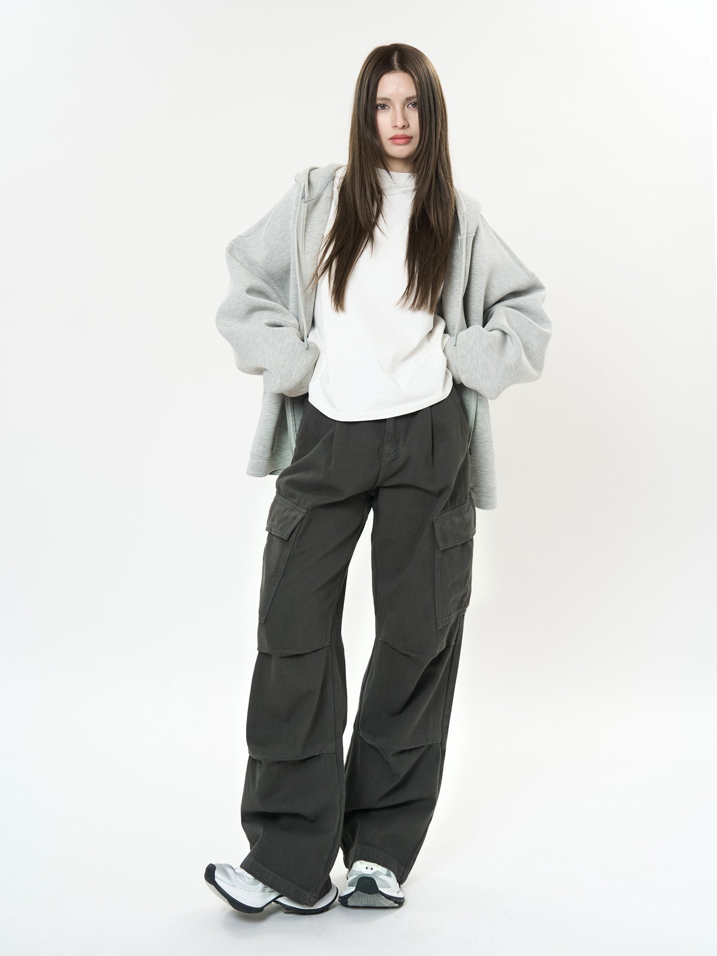 Model wearing Retro Cargo Pocket Wide Leg Denim Pants styled with a grey hoodie and white shirt