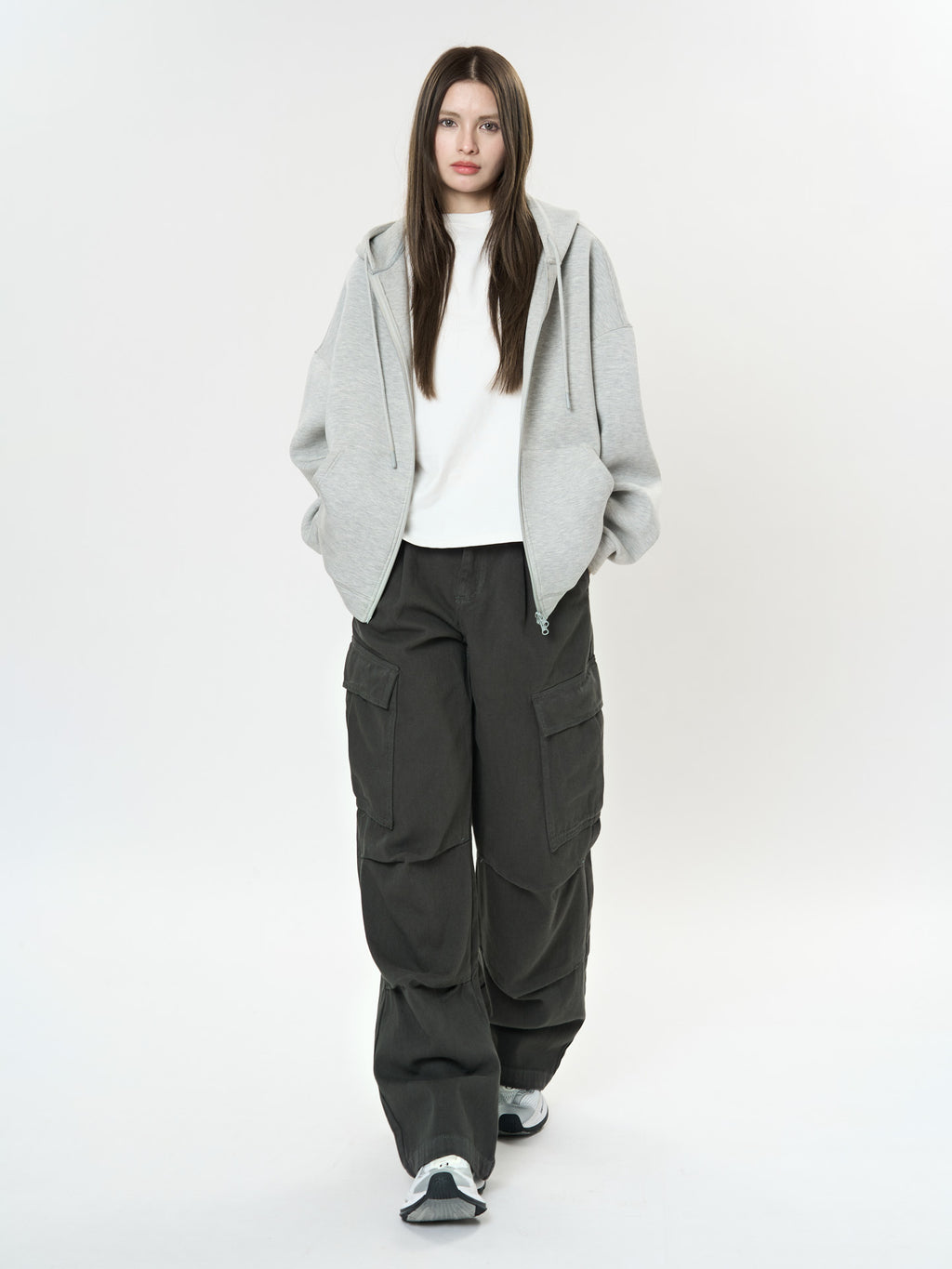 Model wearing Retro Cargo Pocket Wide Leg Denim Pants in dark color with a casual gray hoodie