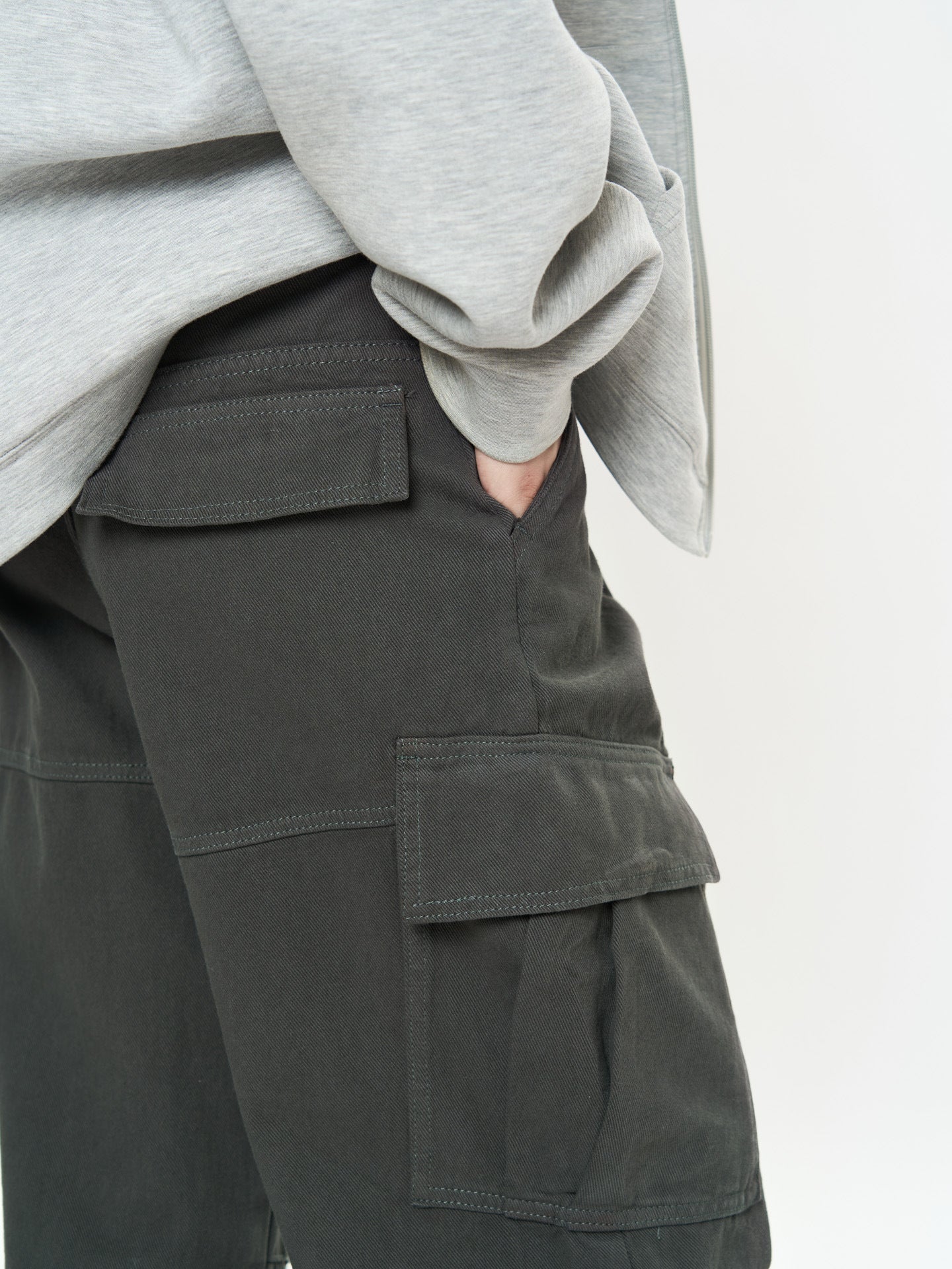 Close-up of Retro Cargo Pocket Wide Leg Denim Pants styled with a gray sweatshirt