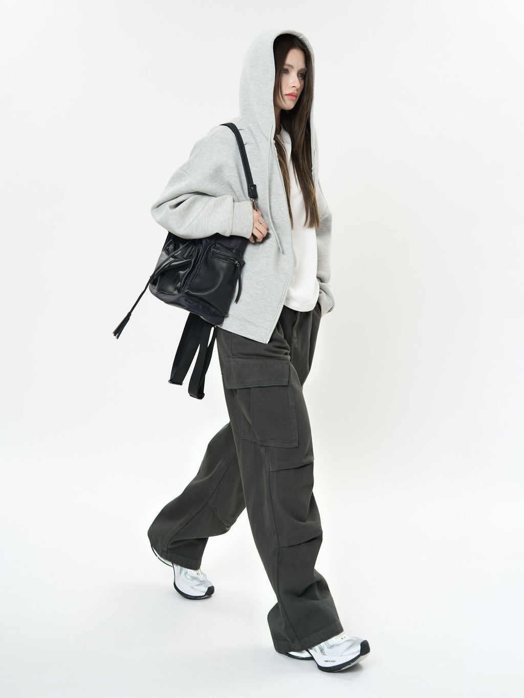 Model wearing Retro Cargo Pocket Wide Leg Denim Pants with a gray hoodie and stylish black bag