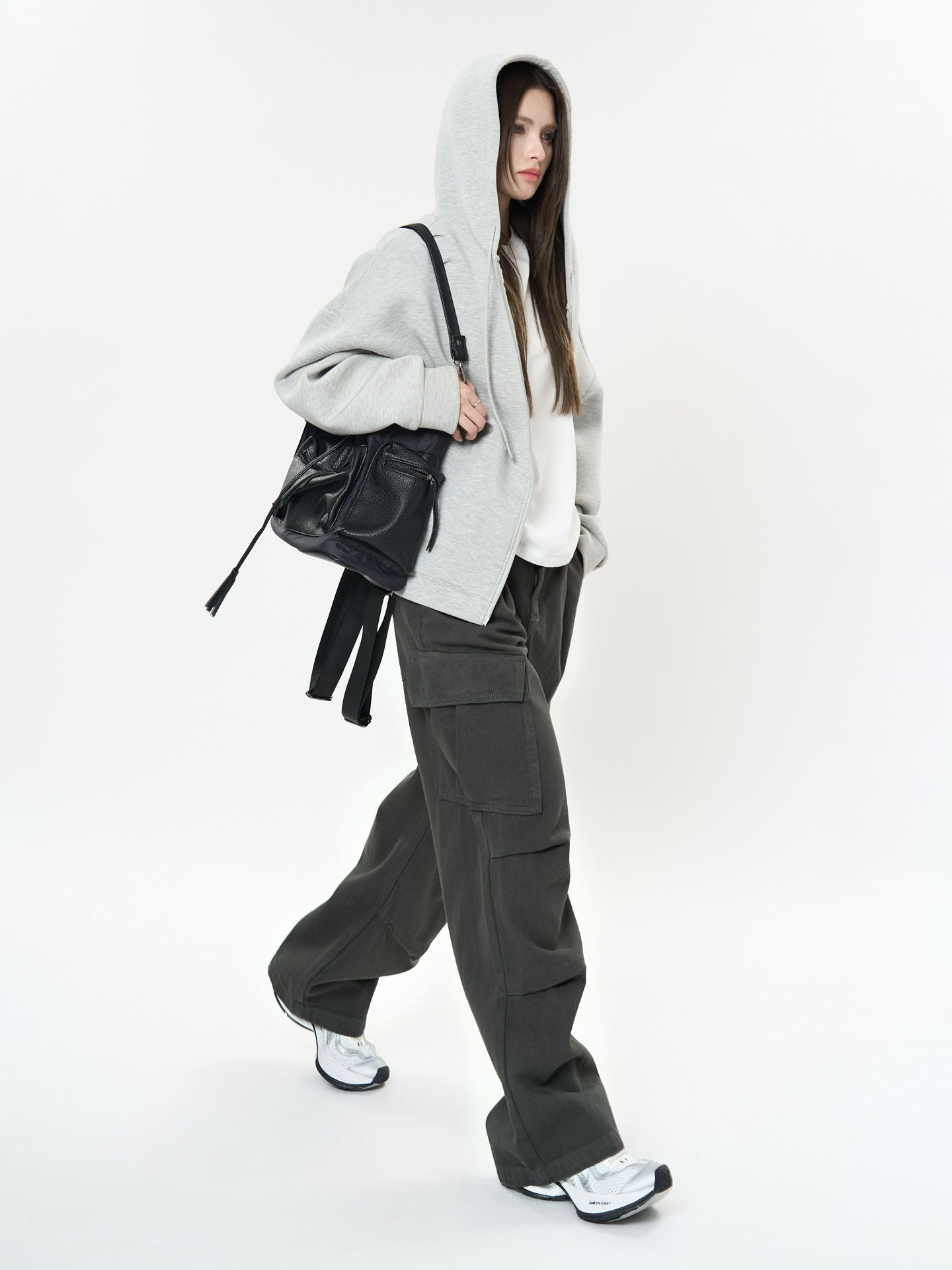 Model wearing Retro Cargo Pocket Wide Leg Denim Pants with a gray hoodie and stylish black bag