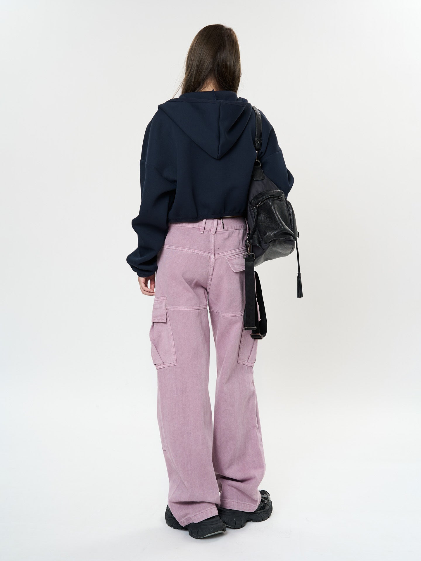 Woman wearing Retro Cargo Pocket Wide Leg Denim Pants in light pink with a black hoodie and bag