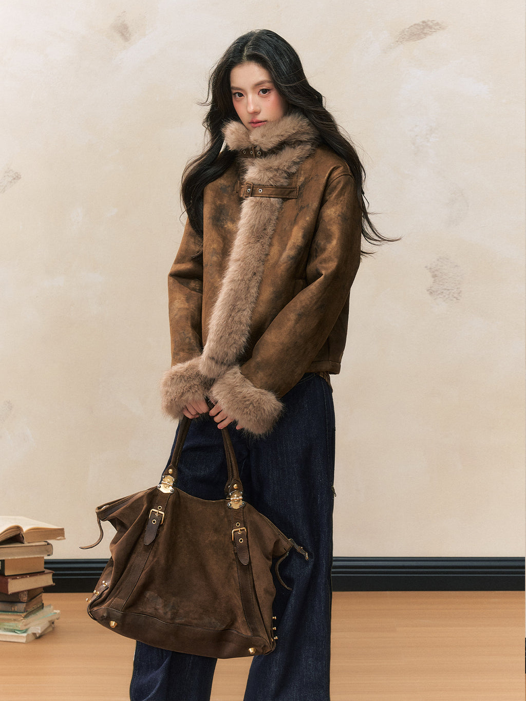 Woman wearing a Retro Maillard Suede Jacket with fur details, paired with a stylish handbag