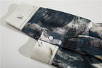 Close-up of AM Vision RO retro tie-dye shirts showcasing unique patterns and buttoned cuffs