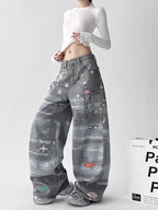 Model wearing Retro Washed Distressed 3D Print Chain Jeans with unique graphic designs and a relaxed fit