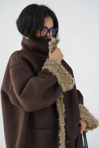 Model wearing a Reversible Winter Suede Jacket in brown with plush fur trim for added warmth and style
