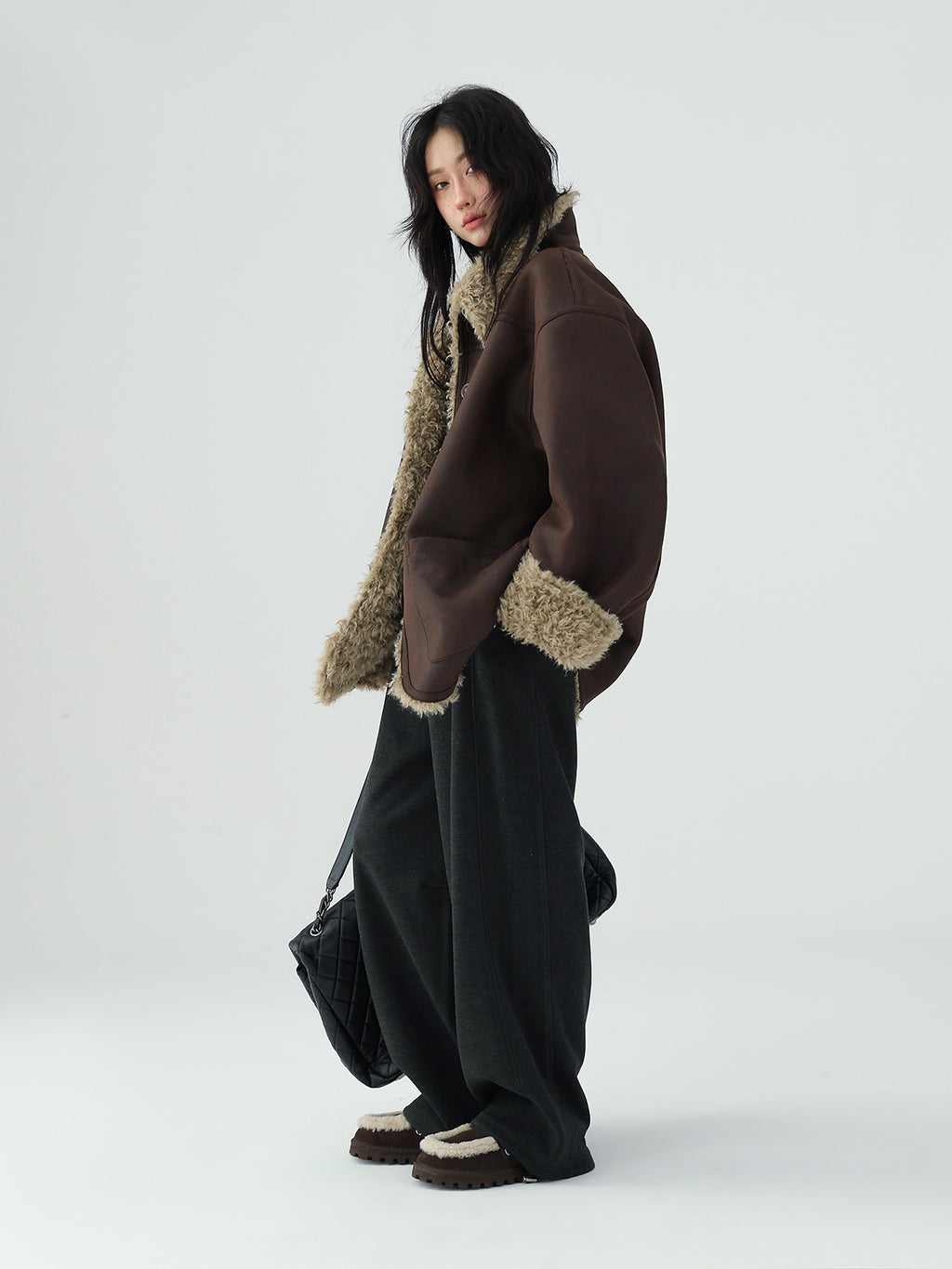 Model wearing a stylish Reversible Winter Suede Jacket in brown and beige for a trendy winter look