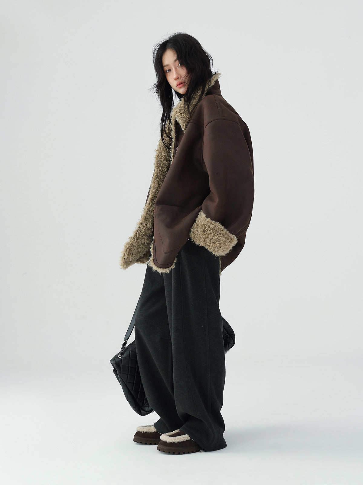 Model wearing a stylish Reversible Winter Suede Jacket in brown and beige for a trendy winter look