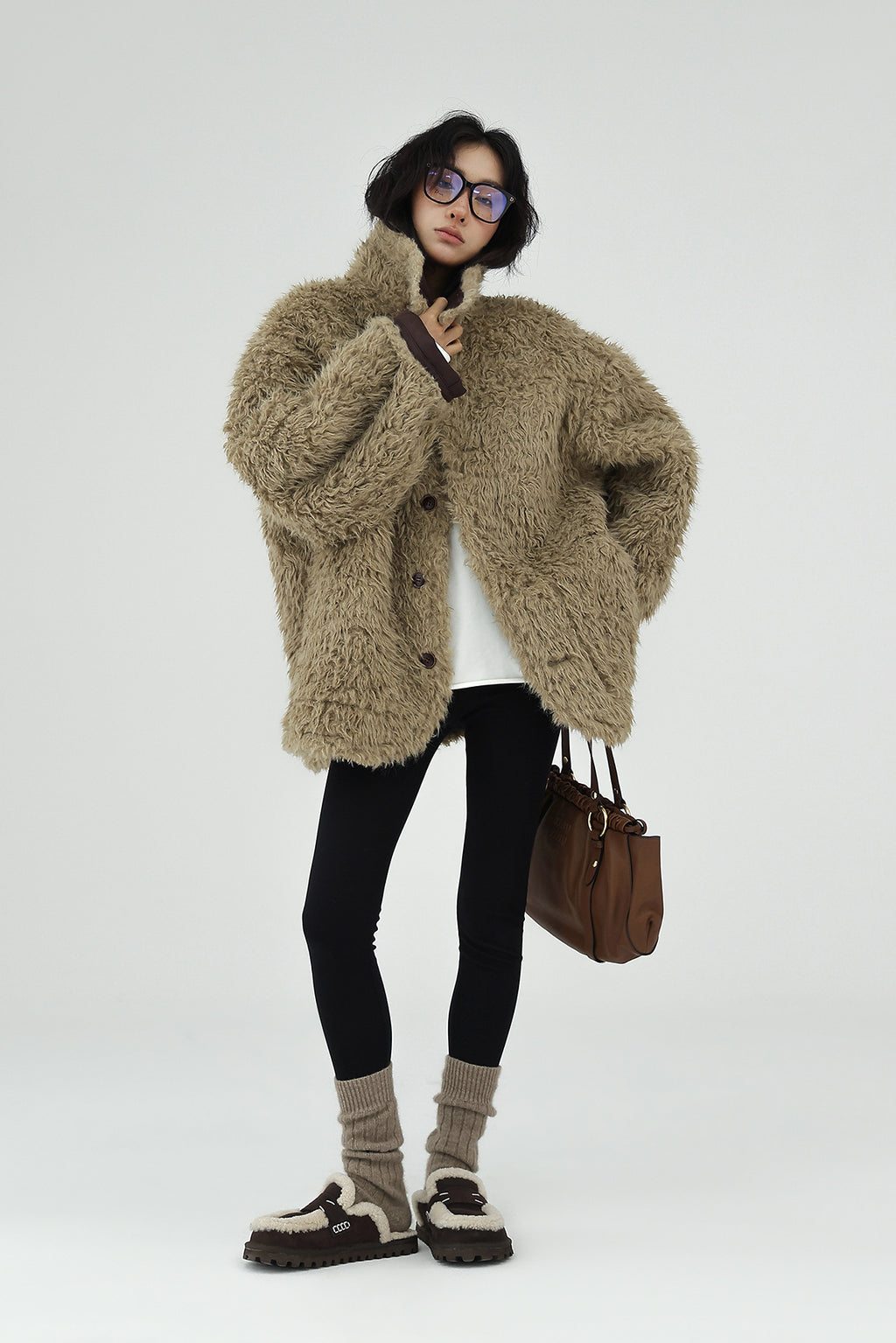 Model wearing a cozy AM Vision RO Reversible Winter Suede Jacket styled with leggings and winter accessories