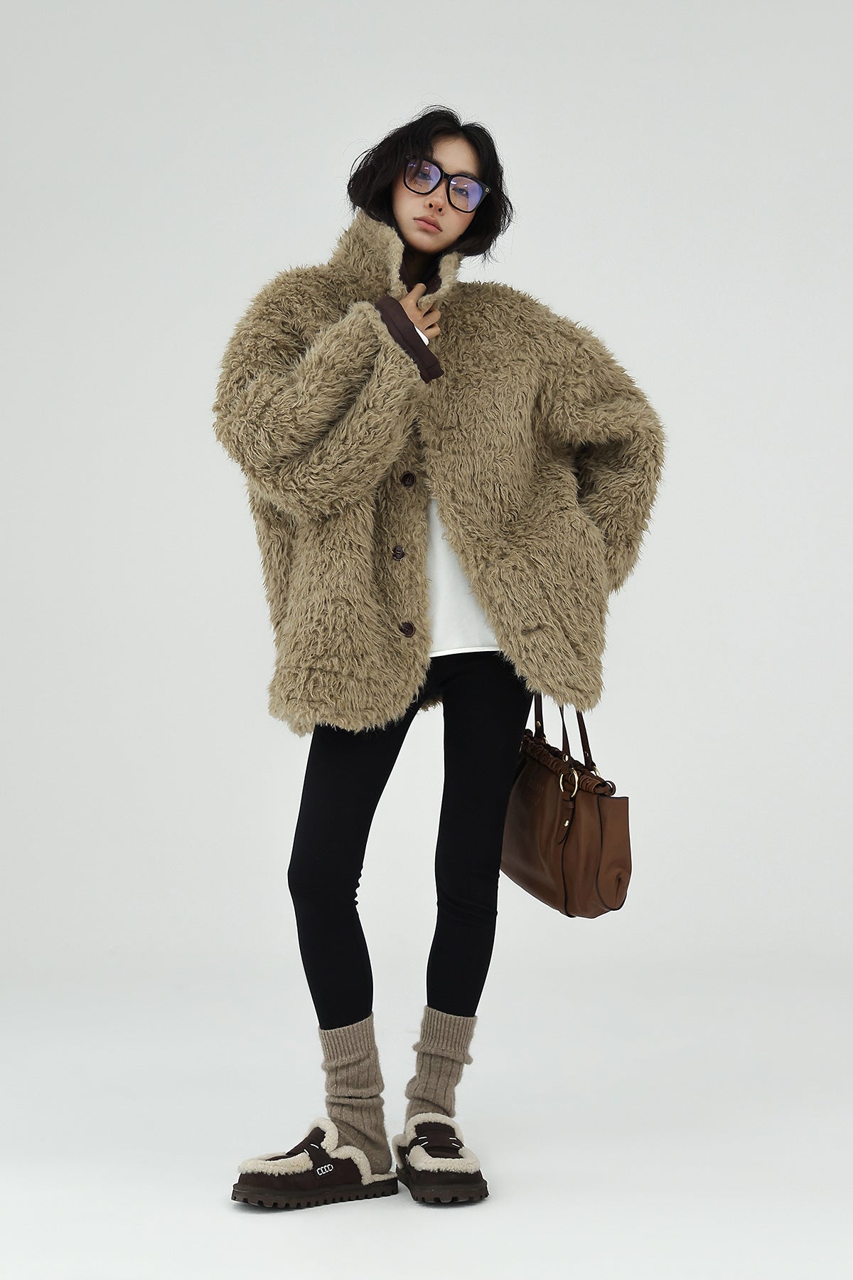 Model wearing a cozy AM Vision RO Reversible Winter Suede Jacket styled with leggings and winter accessories