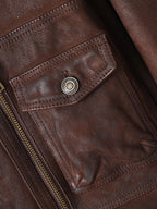 Close-up of the pocket detail on the Rheon Wool Collar Goatskin Moto Jacket in rich brown leather