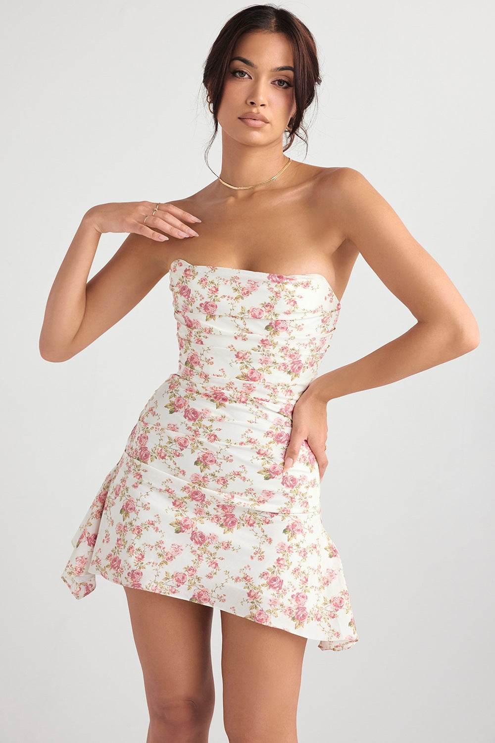 Rochie mini elegantă fară bretele cu imprimeu floral roz și alb purtată de femeie tânără