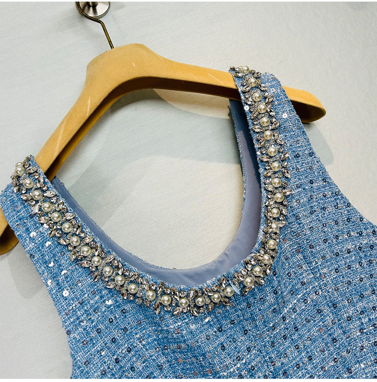 Close-up of the neckline of a blue Sequined Bow Sleeveless Vest Dress with decorative beading