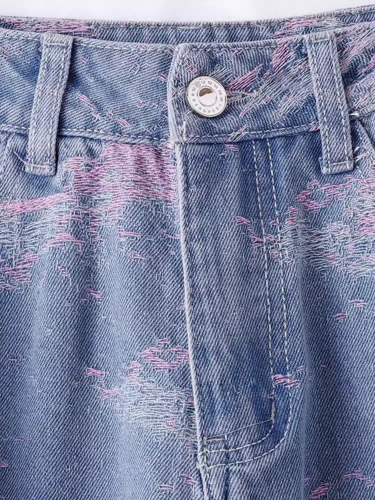 Close-up of Soft Pink Stitch Jeans featuring distressed denim and unique stitching detail