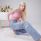 Model wearing Soft Pink Stitch Jeans paired with a matching pink top in a floral setup