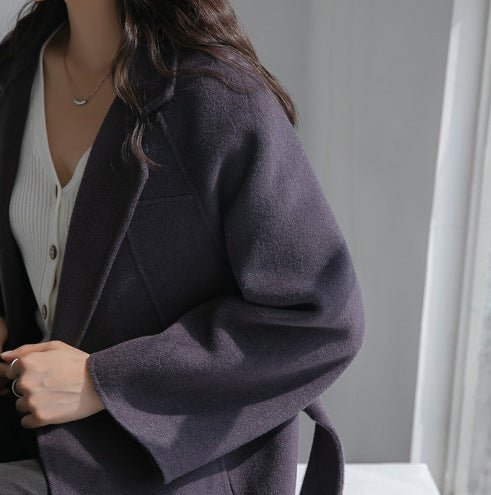 Stylish model wearing a Sophisticated Wool Coat in a cozy indoor setting