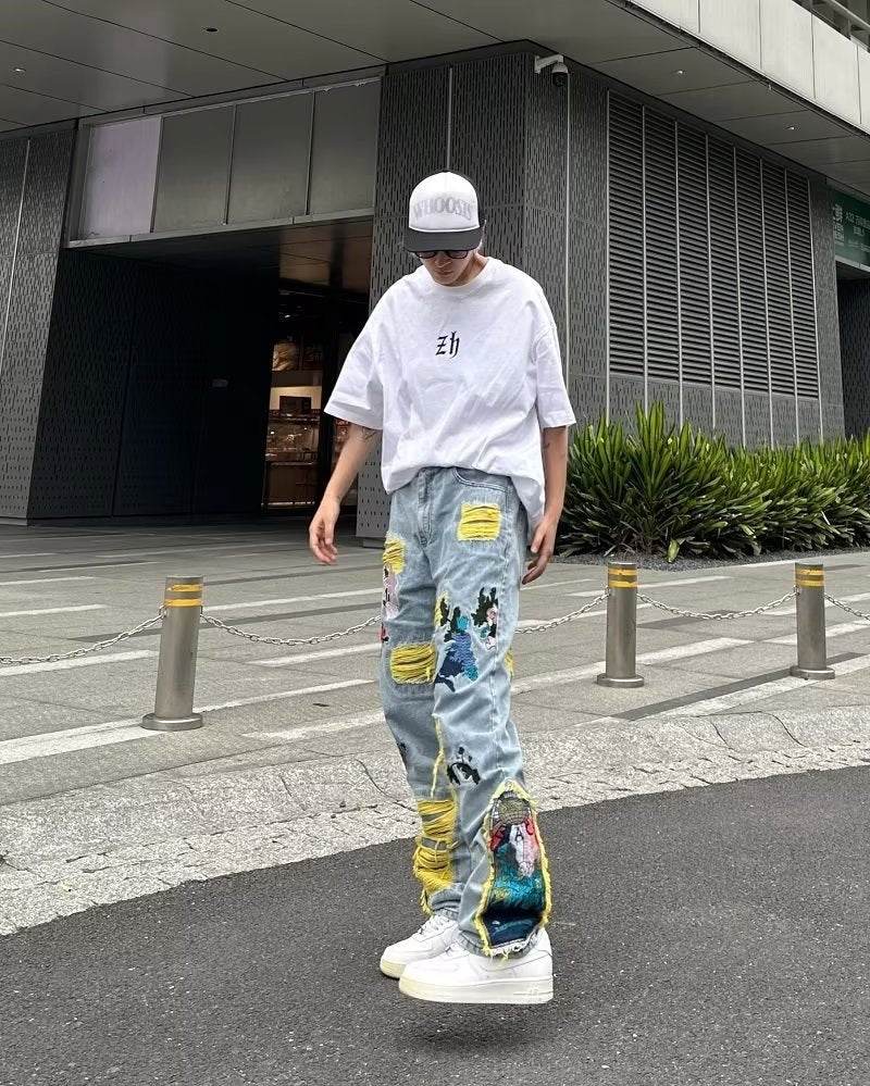 Model wearing AM Vision RO Straight Fit Jeans with Artistic Design in a trendy urban setting