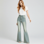 Woman wearing stretch flared jeans in light blue with a white shirt for a stylish casual look