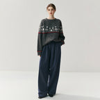 Cozy Christmas knitwear sweater with festive patterns, styled with loose navy pants for a relaxed holiday look