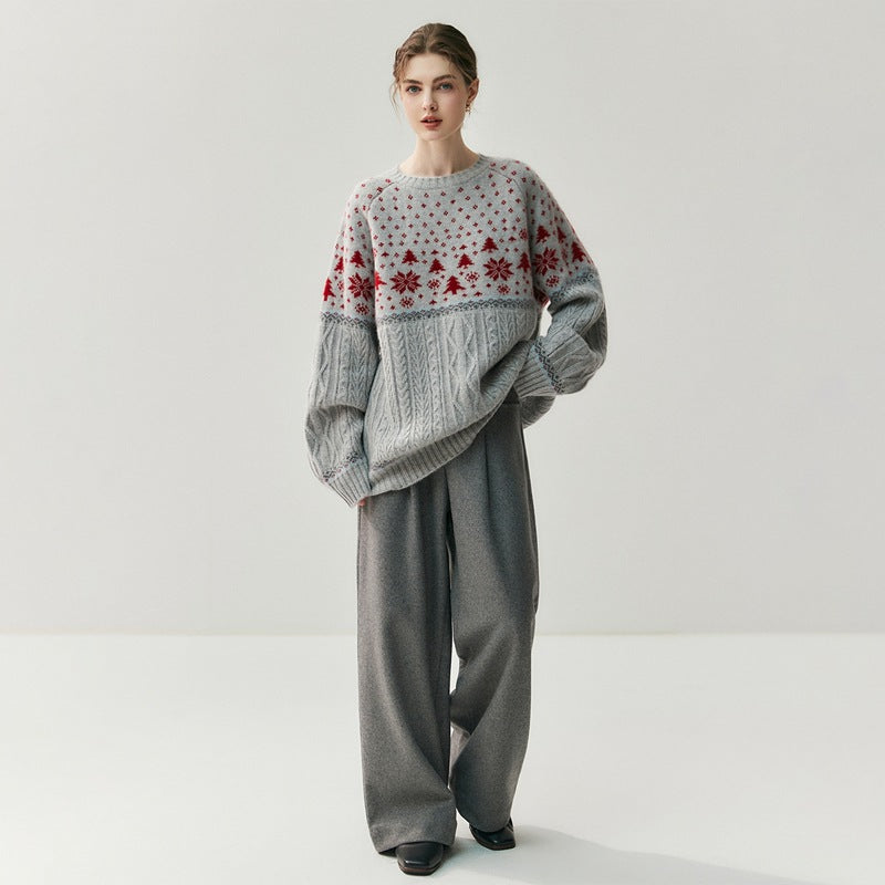 Stylish model wearing cozy Christmas knitwear with a festive design and wide gray trousers