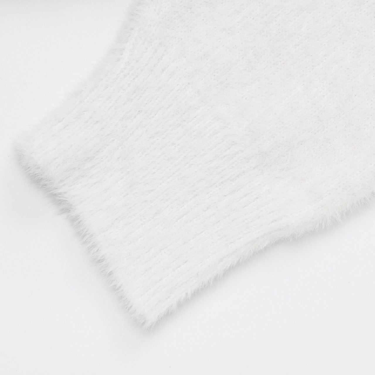 Soft white Sweet Bear Knit Sweater sleeve detail showcasing fluffy texture and ribbed cuff